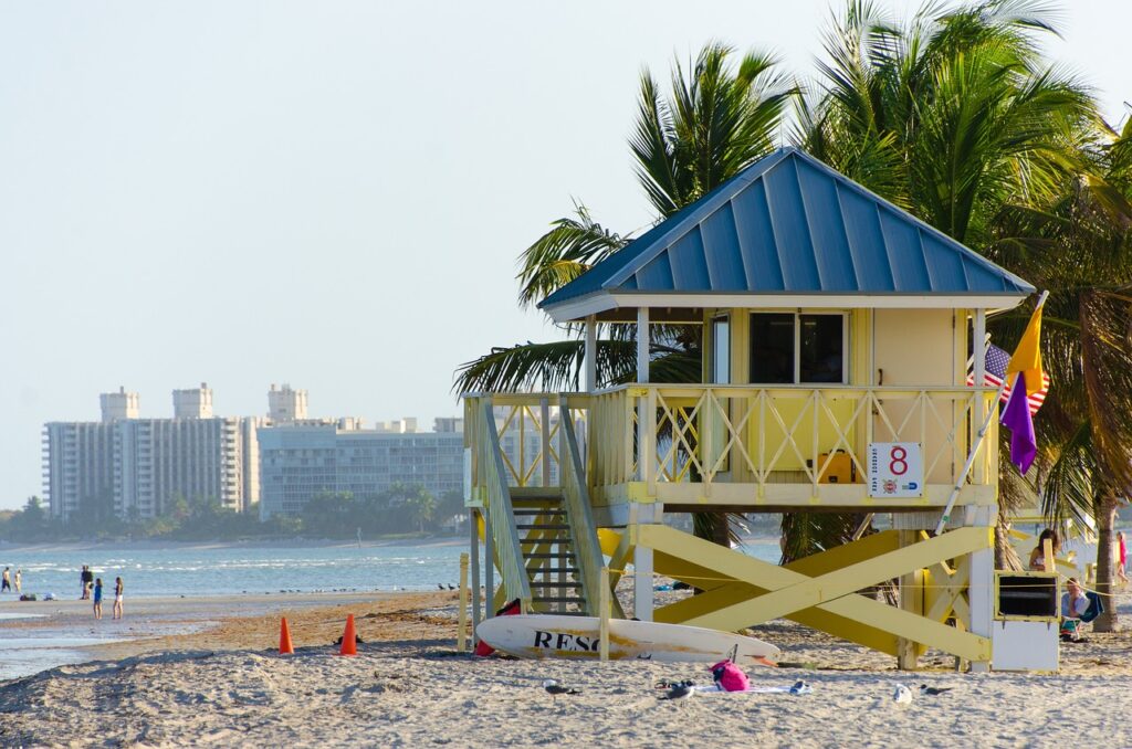 Lifeguard tower on Miami beach with city skyline in background, representing Valvian Capital’s Florida roots and local expertise